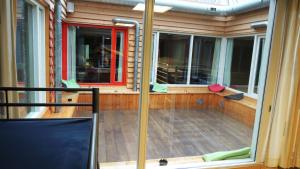 a screened in porch of a house with a window at 3BE Backpackers Bed & Breakfast Eindhoven in Eindhoven