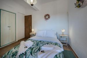 a bedroom with a bed with a blue comforter at Villa Dianne Apt 1 Livadi Arachovas in Arachova