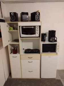 a small kitchen with a microwave oven and a microwave at Naudebals in Rebourguil