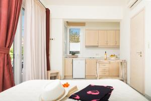 a bedroom with a bed and a kitchen at Hotel Sunshine Matala in Matala