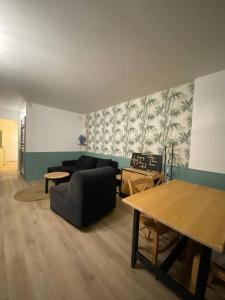 a living room with a couch and a table at Le nid vert in Eaux-Bonnes