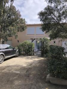 a car parked in front of a house at Studio Rez de jardin dans résidence privée près de la plage in Calvi