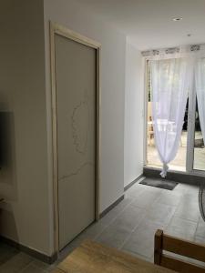 a door with a map on it in a room at Studio Rez de jardin dans résidence privée près de la plage in Calvi