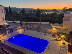 a large blue swimming pool on top of a building at Polis Mountain and Sea view apartment in Polis Chrysochous