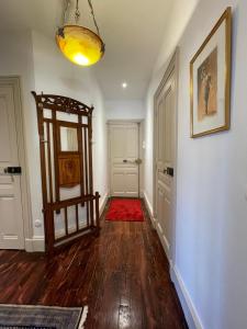 un couloir avec un tapis rouge et une porte dans l'établissement Maison Pignol, au Puy-en-Velay