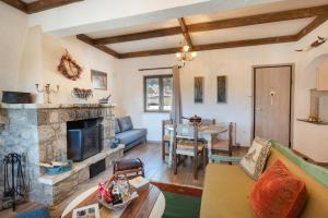 a living room with a couch and a fireplace at Villa Dianne - Your Home in Mount Parnassos in Arachova +40 photos