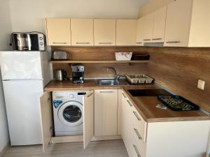 a small kitchen with a sink and a washing machine at Частен апартамент Стамополу - Private Two-Bedroom Apartment Stamopolu in Primorsko