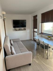 a living room with a couch and a table at Частен апартамент Стамополу - Private Two-Bedroom Apartment Stamopolu in Primorsko