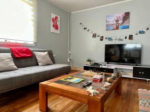 a living room with a couch and a coffee table at Patagonia Sweet Home in Puerto Natales