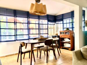 a dining room with a table and chairs at V&V Beach House in Punta Cana