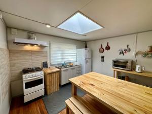 a kitchen with a stove and a refrigerator at Patagonia Sweet Home in Puerto Natales