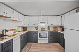 a kitchen with white cabinets and a white refrigerator at RANDALL LAKE RETREAT-LIMIT 7 villa 