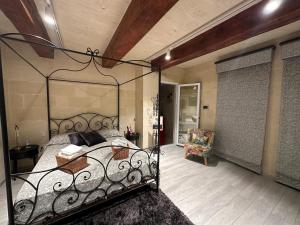 a bedroom with a wrought iron bed in a room at Ta Pinu Spa Suite - Luxury Heritage Living in Żebbuġ