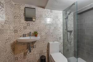 a bathroom with a sink and a shower and a toilet at Unique studio loft, walking distance to Valletta in Hamrun