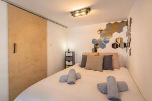 a bedroom with a large white bed with two pillows at Unique studio loft, walking distance to Valletta in Hamrun