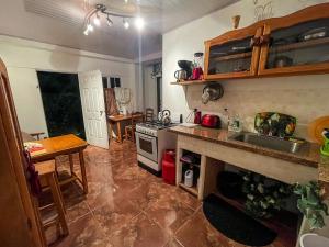 a kitchen with a sink and a stove top oven at Tranquil guest House in Buccoo