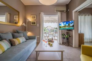 a living room with a blue couch and a table at Glyfada's Central Apartment in Athens