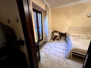 a bedroom with a bed and a room with a window at Casa Felice in Cercola