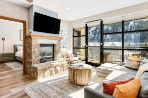 a living room with a fireplace and a tv at Chapel Place in Avon
