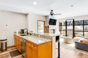a kitchen with a sink and a living room at Chapel Place in Avon +37 photos