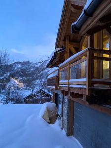 a house with snow on the side of it at Châlets AOKI in Valloire