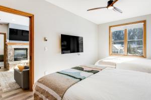 a bedroom with two beds and a tv at Chapel Place in Avon