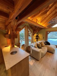 a living room with a couch and a table at Châlets AOKI in Valloire