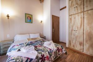 a bedroom with a bed and a wooden closet at Villa Dianne - Your Home in Mount Parnassos in Arachova