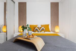 a bedroom with a bed with a tray of food on it at Birmingham City Centre Luxury Apartment in Birmingham