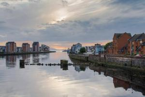 a view of a river with houses and buildings at Stunning Refurbished 1 Bedroom, Harbour Apartment. in Ayr