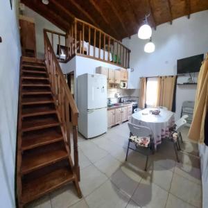 a kitchen with a table and a white refrigerator at Los manzanos . in Colón