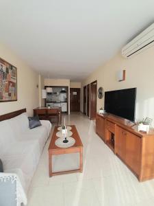 a living room with a couch and a flat screen tv at nice apartment in hotel ronda 4 first beach line in Fuengirola