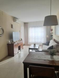 a living room with a couch and a table at nice apartment in hotel ronda 4 first beach line in Fuengirola