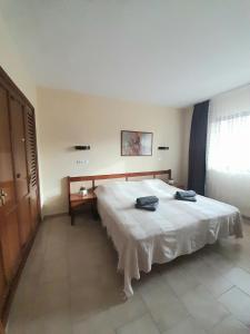 a bedroom with a large white bed in a room at nice apartment in hotel ronda 4 first beach line in Fuengirola