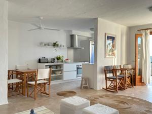a kitchen and dining room with a table and chairs at Duplex Son Parc Best Sea Views in Son Parc