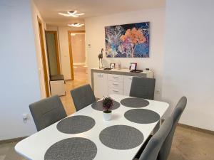 a dining room with a white table and chairs at Corazon de la safor, Ador in Ador