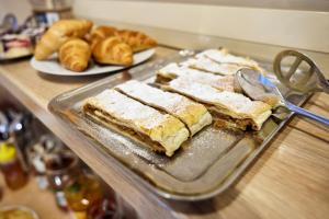 a glass tray with sandwiches on a counter with bread at Residence Ruth in Janske Lazne +36 photos