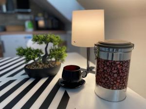a jar of coffee beans next to a lamp on a table at Francis Apartment I- Spa Center Karlovy Vary in Karlovy Vary +3 photos