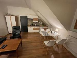 a living room with a table and chairs and a kitchen at Francis Apartment I- Spa Center Karlovy Vary in Karlovy Vary
