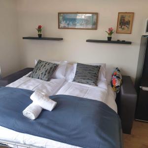 a bedroom with a bed with a teddy bear on it at Magyartenger Apartman Balatonlelle in Balatonlelle
