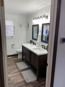 a bathroom with a sink and a toilet and a mirror at Outdoor Sanctuary - 3 min walk to Silver Mtn in Kellogg +47 photos