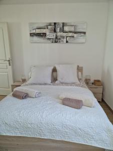 a bedroom with a bed with two pillows on it at Toulon, soleil et douceur I in Toulon