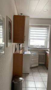 a small kitchen with a sink and a window at FeWo Oberhausen-Alstaden (Gornig) in Oberhausen