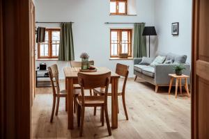 a dining room and living room with a table and chairs at the salt residences in Hallein