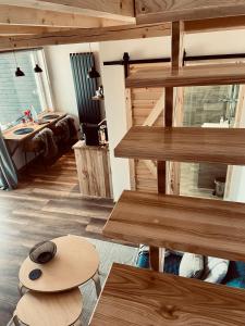 a living room with wooden stairs and a table at Cerla Korbielów - Domek dla Dwojga in Korbielów