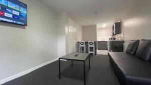 a living room with a couch and a table at Hosted By Ryan - 1 Bedroom Apartment in Liverpool