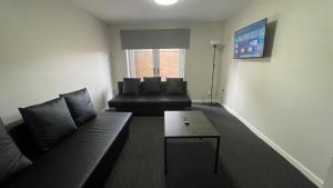 a living room with a couch and a coffee table at Hosted By Ryan - 1 Bedroom Apartment in Liverpool