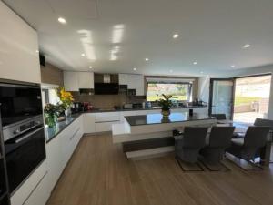 a large kitchen with a table and chairs in it at Villa avec piscine dans la région du Douro in Loureiro