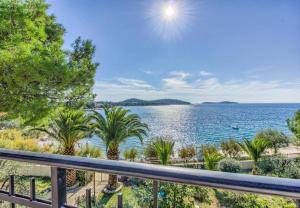 a view of the water from the balcony of a house at Apartmany Rogoznica in Rogoznica