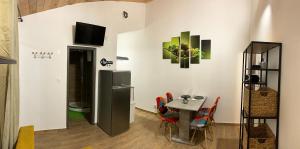 a dining room with a table and a refrigerator at Apartmany Rogoznica in Rogoznica